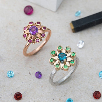 Elegant flower-design rings with colorful gemstones for optimization consultants.